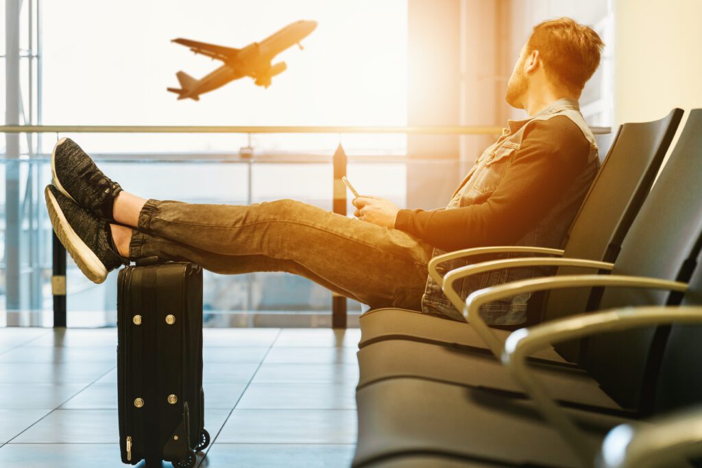 Professional male waiting for his flight to enjoy global expansion benefits in business.